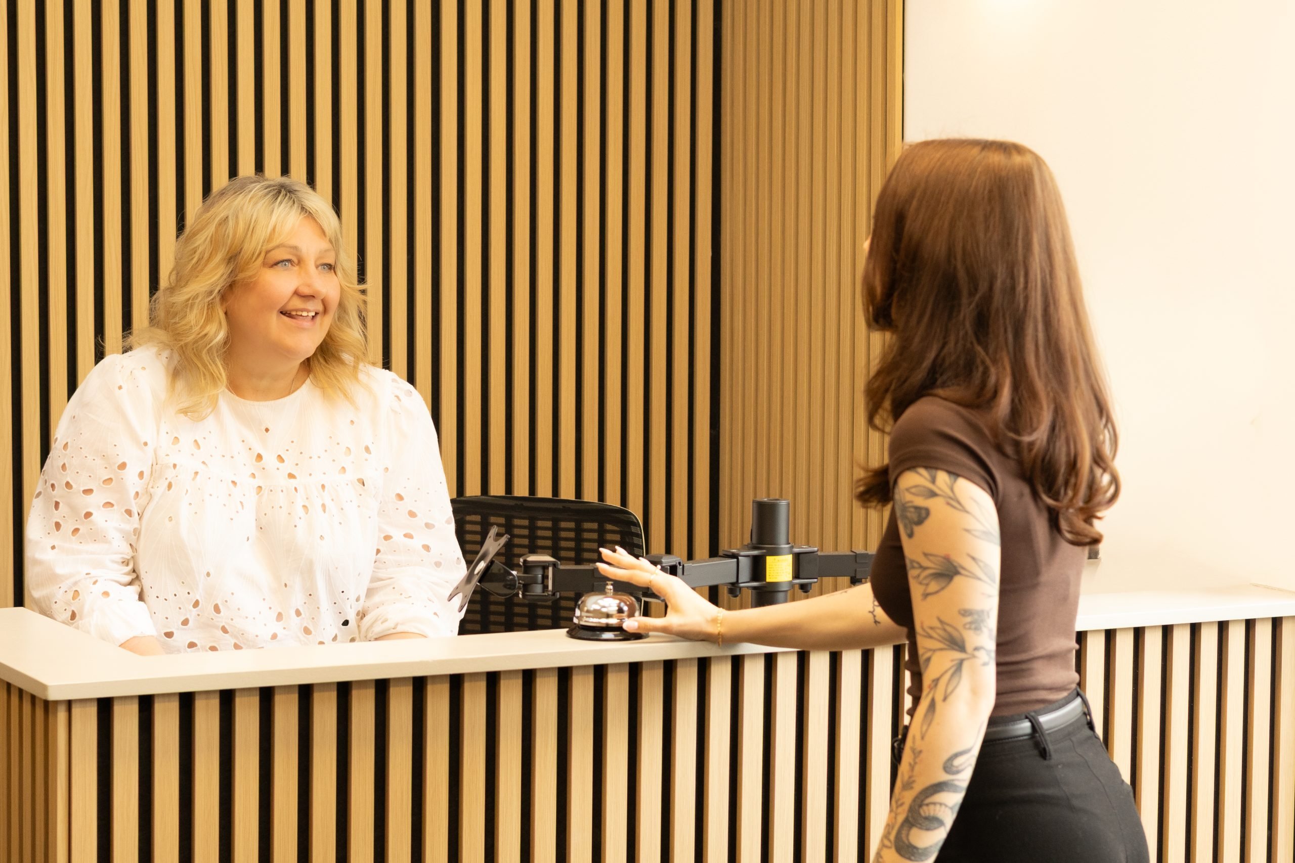 A conversation at the reception desk in Albany Lettings’ Edinburgh office